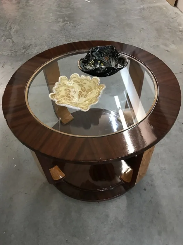 Two antique round tables with decorative accents