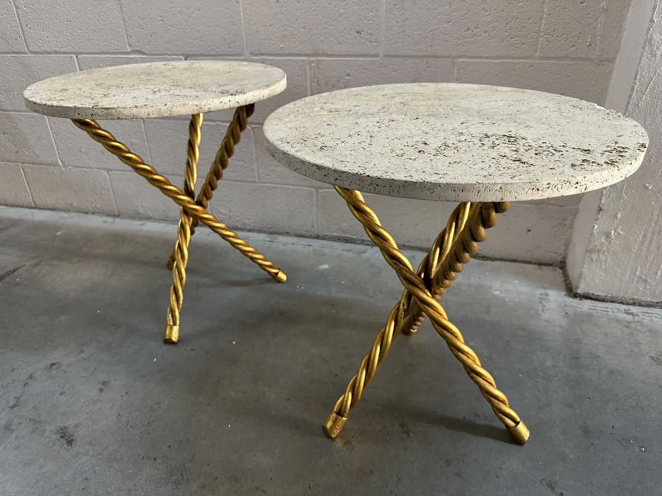two antique small tables with gold legs in a minimalist setting