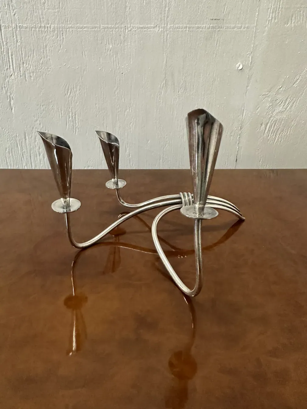 two antique candelabras on a neutral background