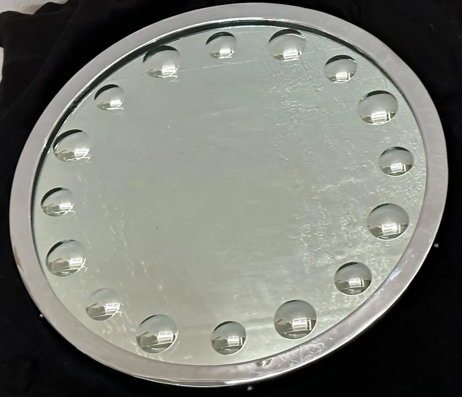 round antique mirror with decorative design