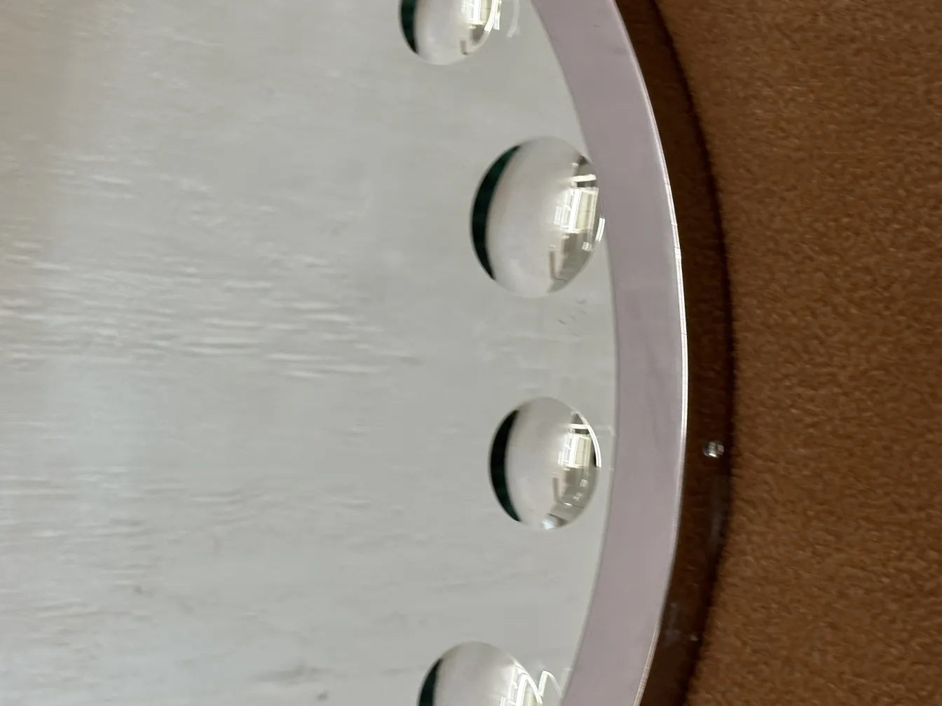 Antique mirror with rounded shape and distinct details.