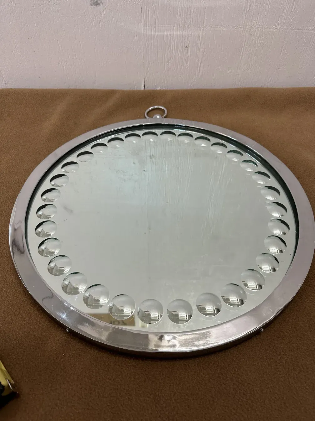 two antique round mirrors with border details