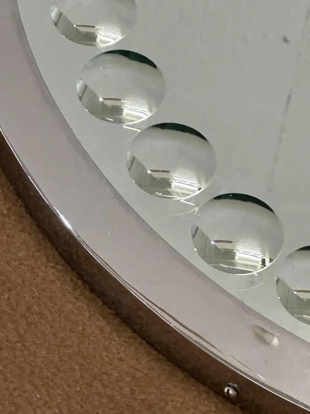 Two antique round mirrors reflecting surroundings