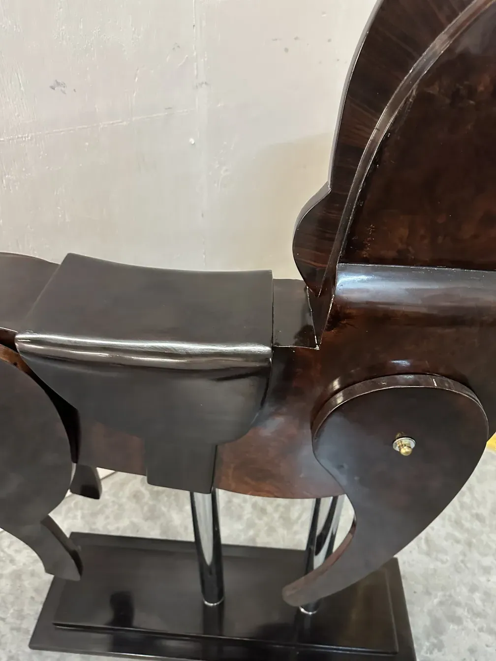 Antique sculpture of two horses in a decorative setting.