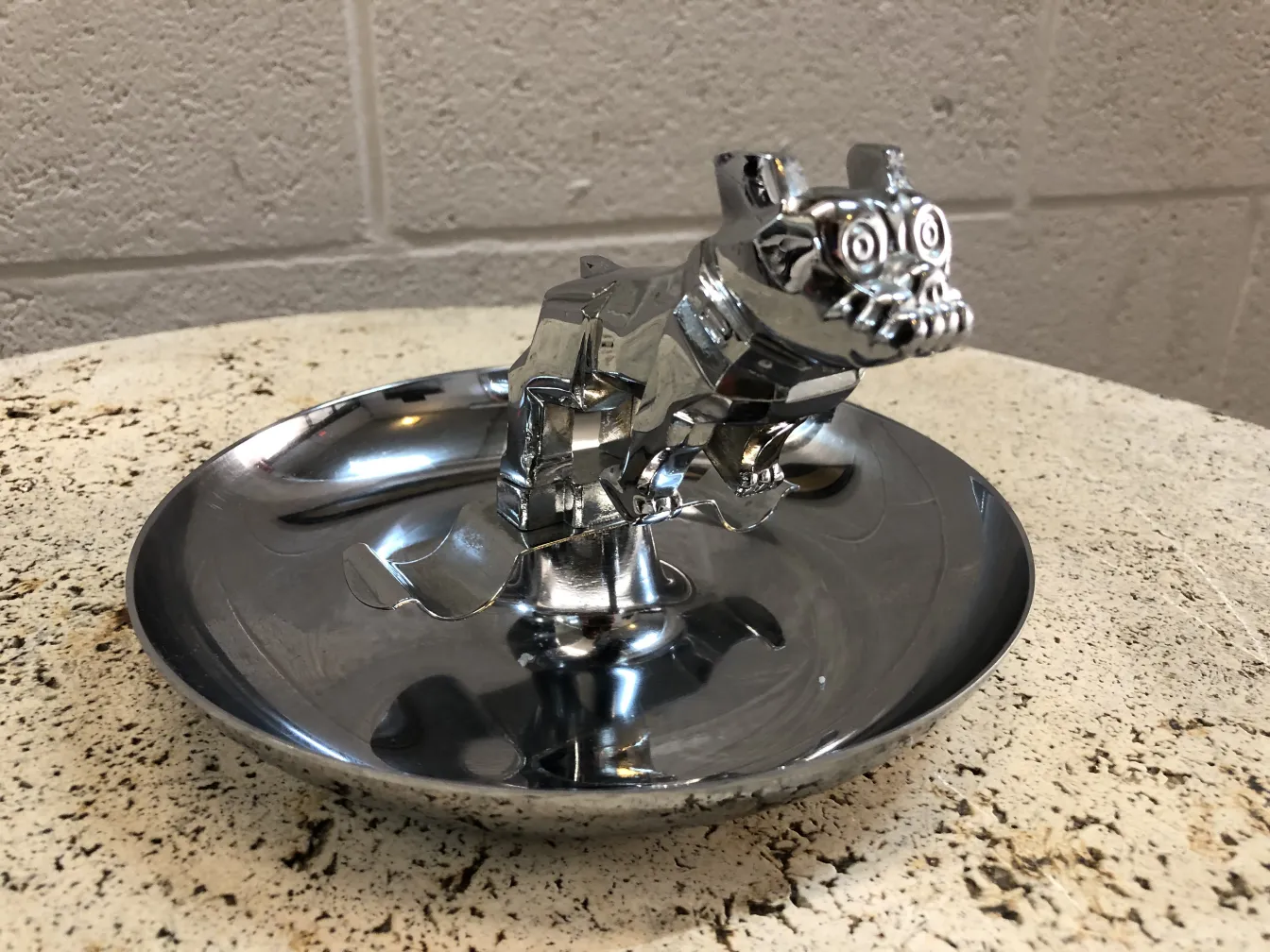 Antique ashtray featuring a shiny animal design