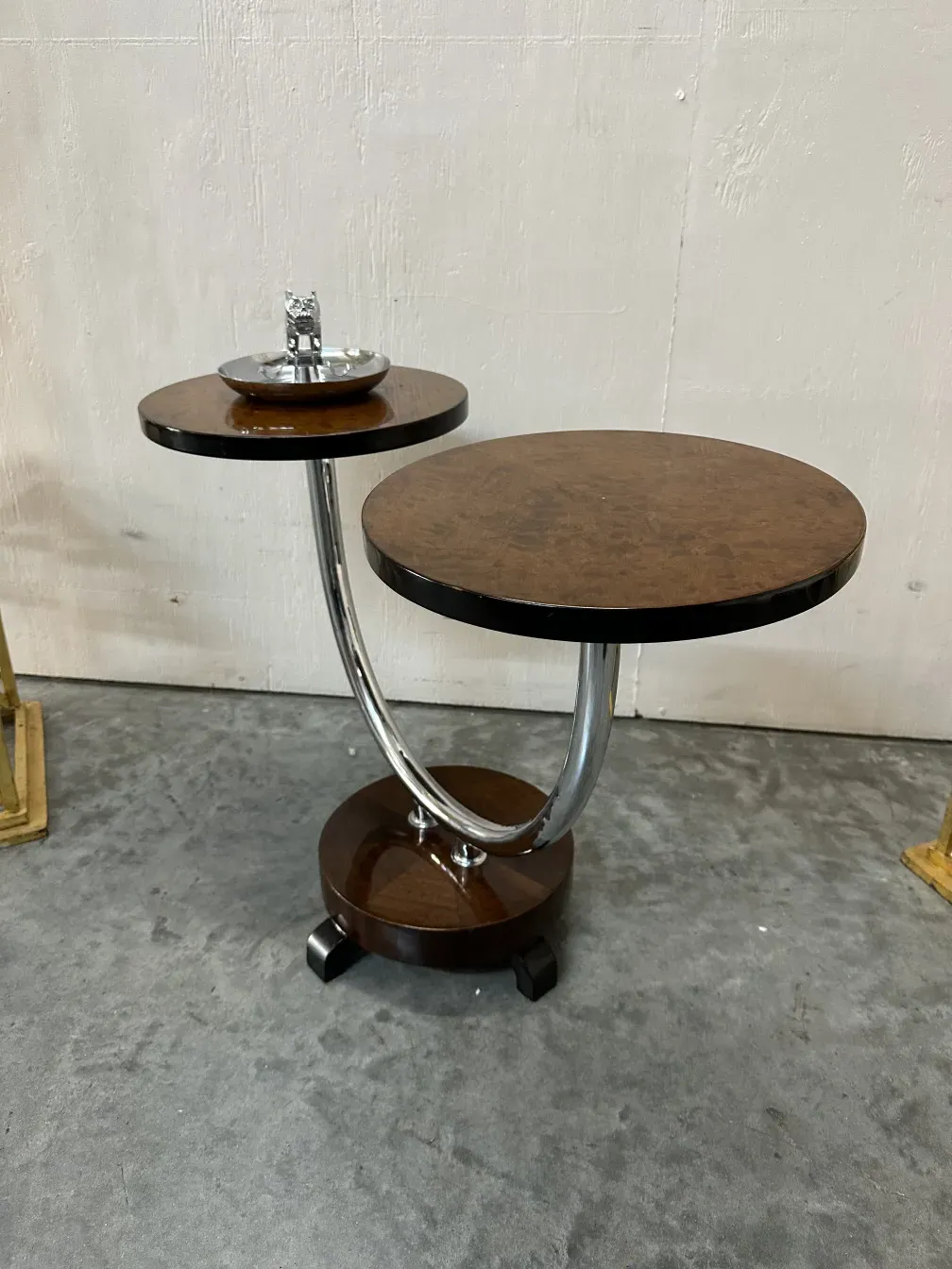 Antique ashtray with a decorative table and support.