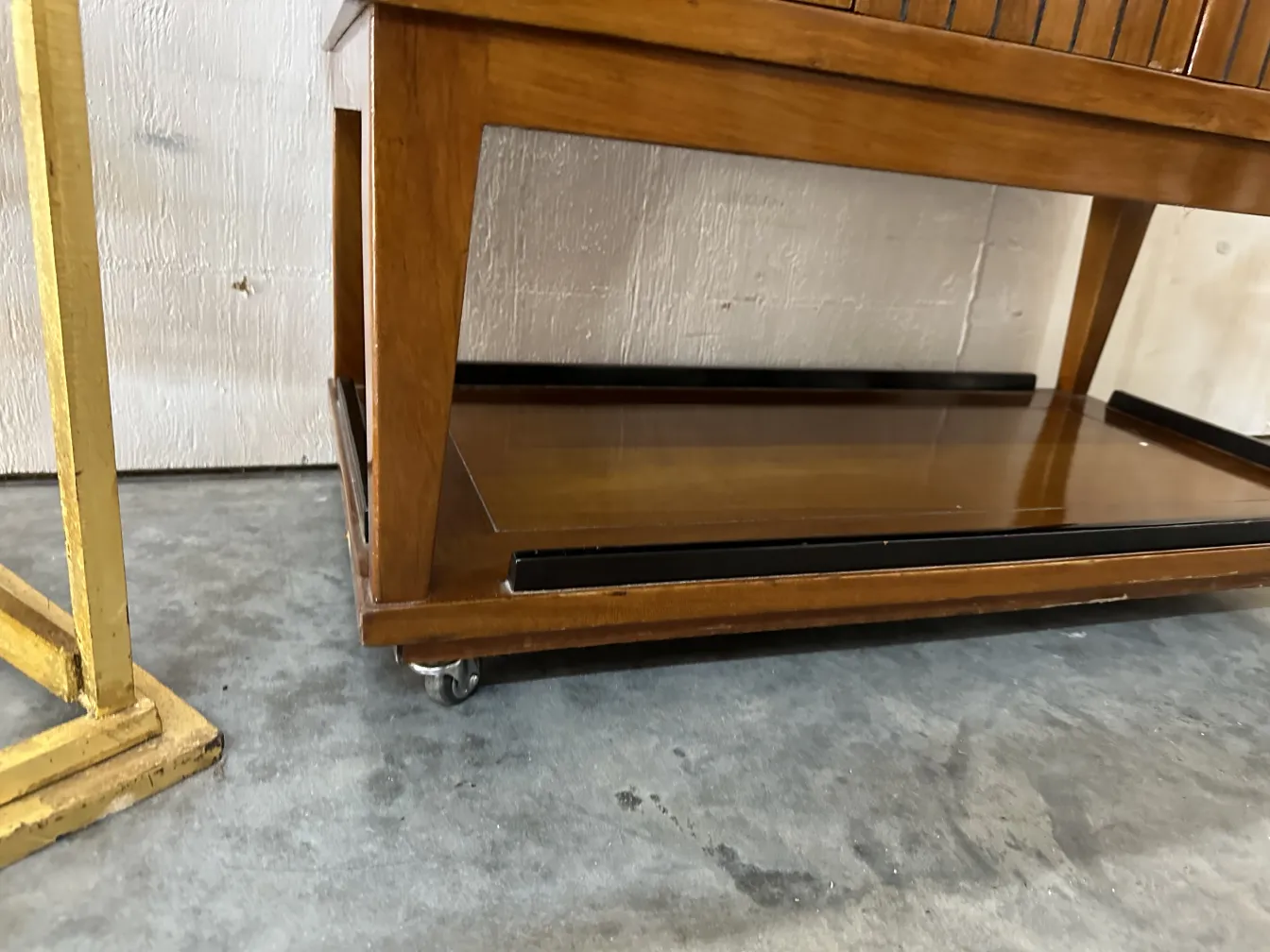 Antique bar cabinet on wheels in a modern setting.