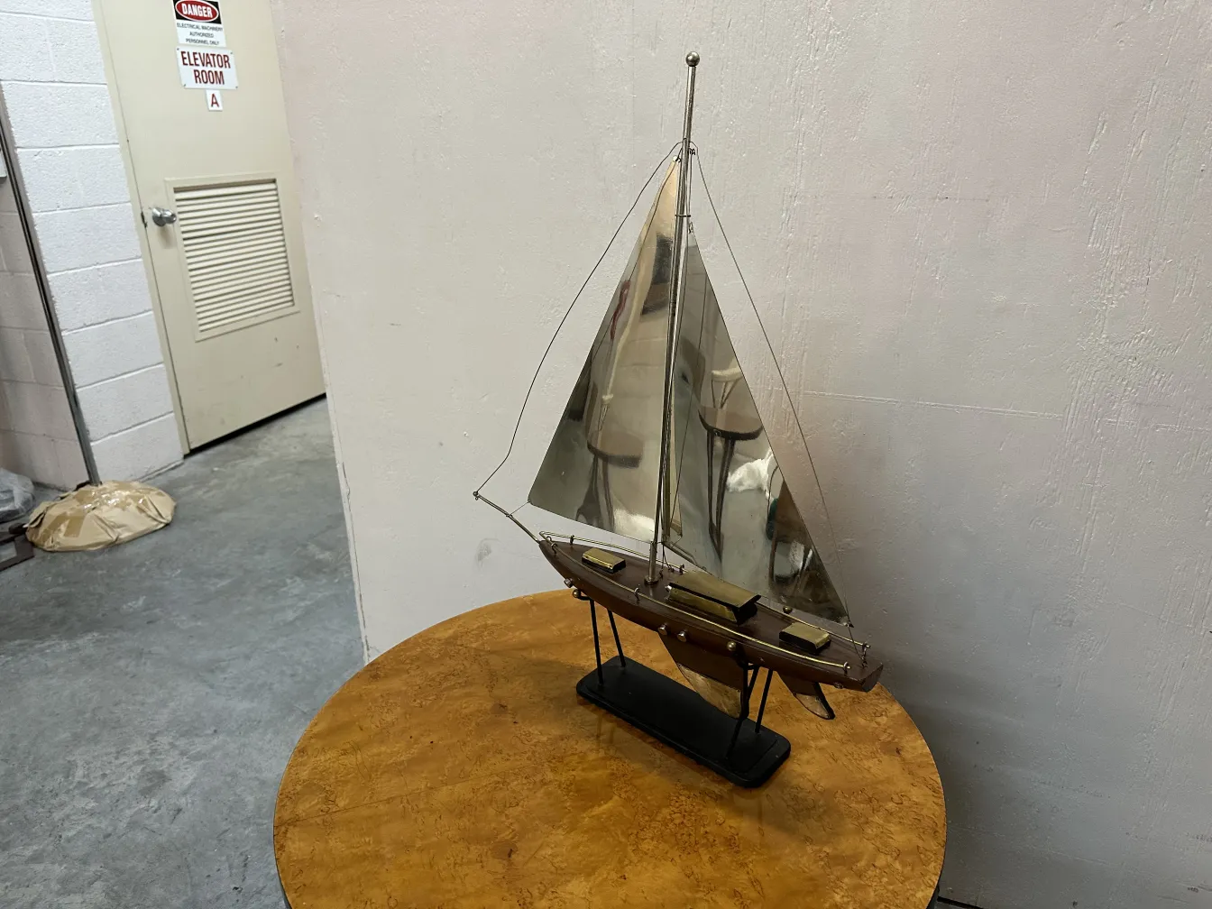 Old designer's ship displayed on a table, white background
