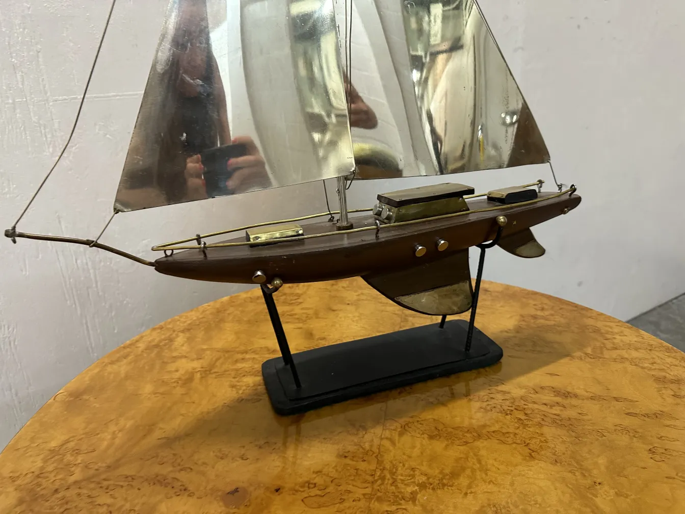 Designer ship model with sails set in an antique setting.
