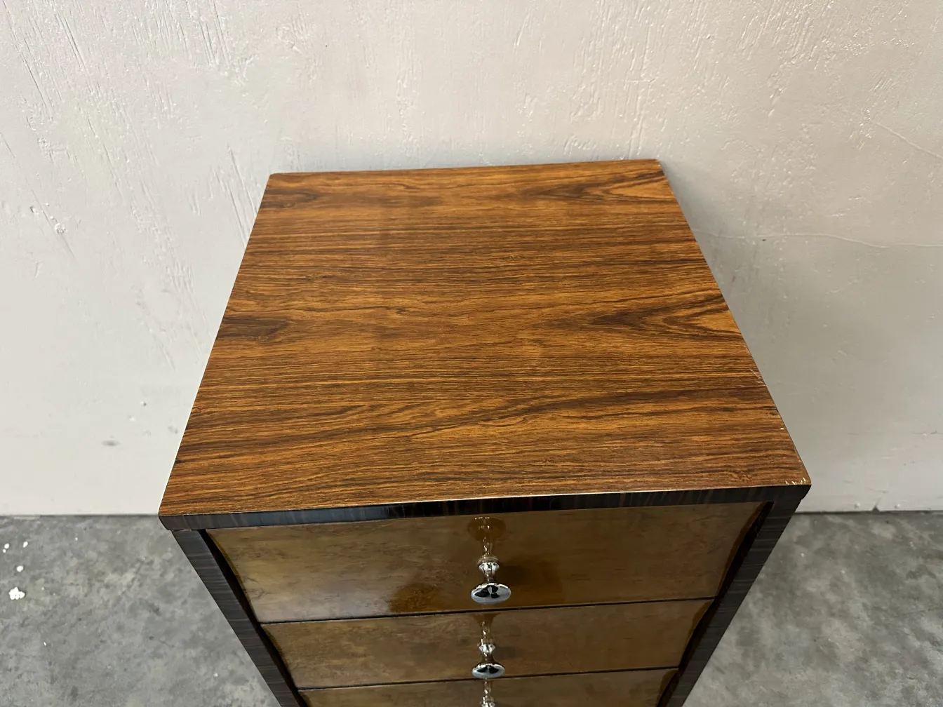 Antique cabinet featuring a stylish top and sleek handles