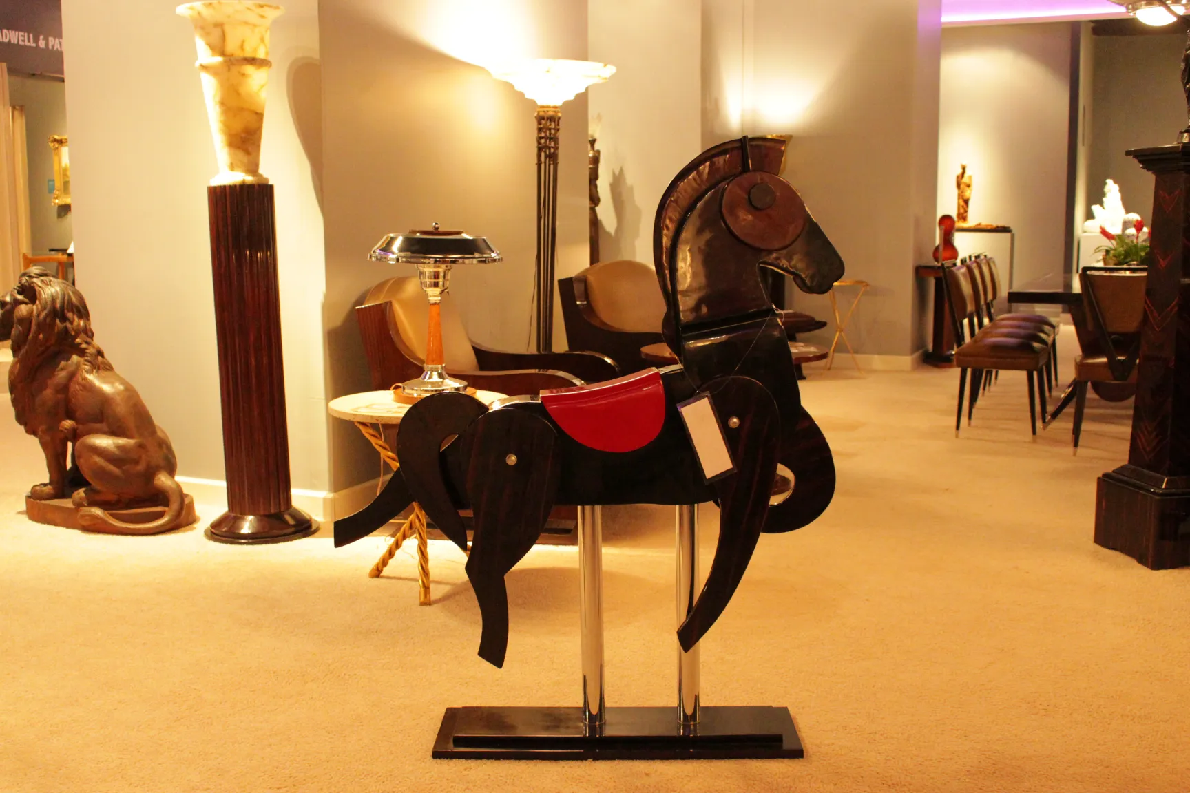 antique decorative horse with red accents in a stylish setting