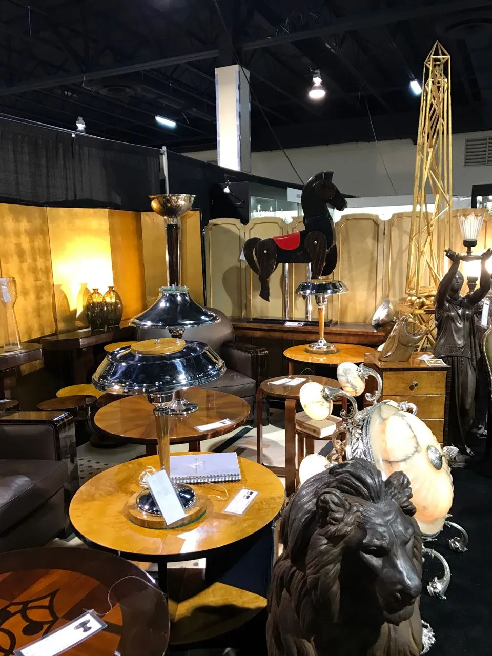 antique decorative horse in an antiques market, surrounded by furniture and decor