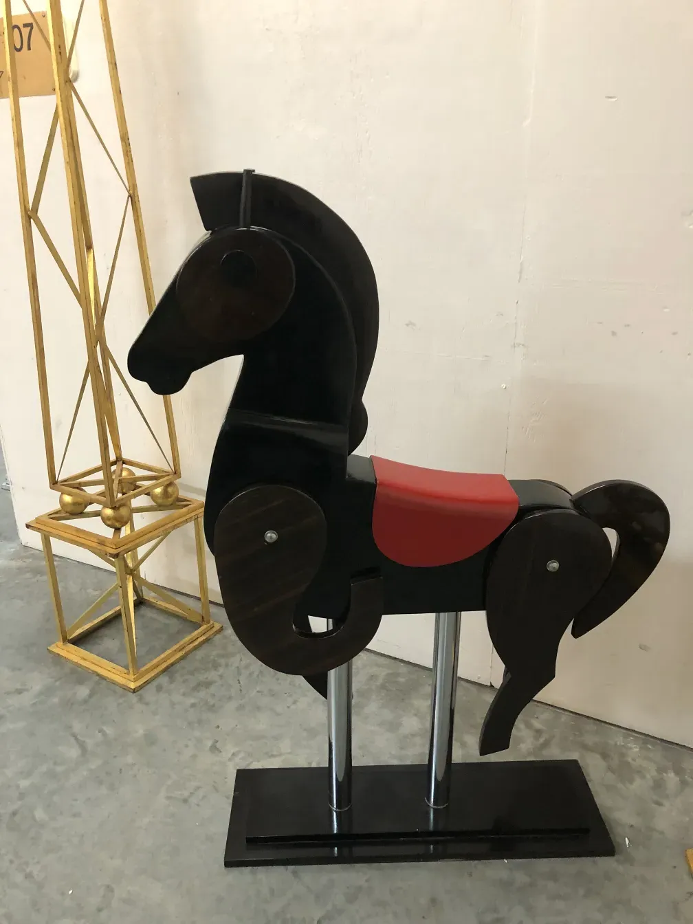 Antique horse toy in a minimalist setting.