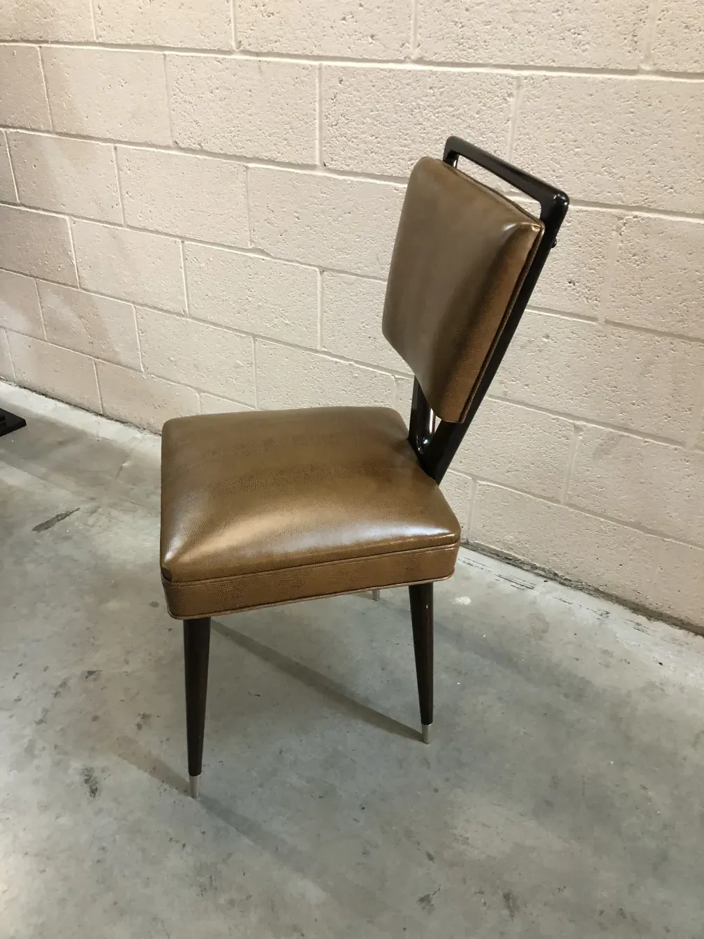 Antique carlo mollino chair with unique design in a neutral setting