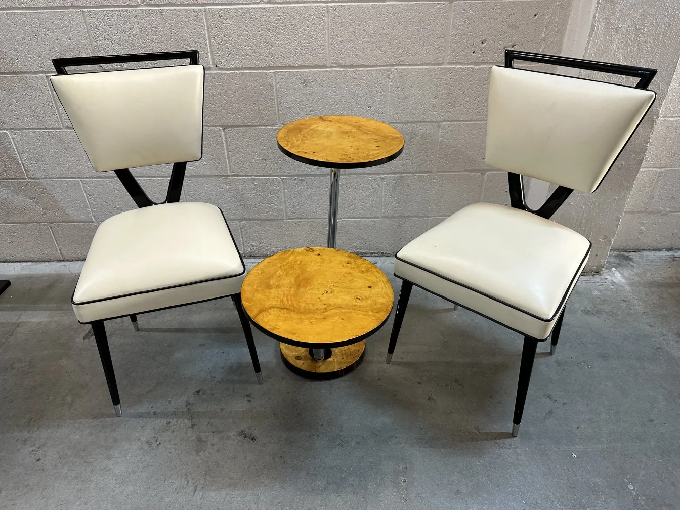 2 antique chairs designed by carlo mollino featuring distinctive backs and white seats