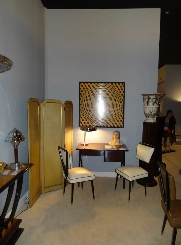 Two antique carlo mollino white chairs in an elegant setting with decor.