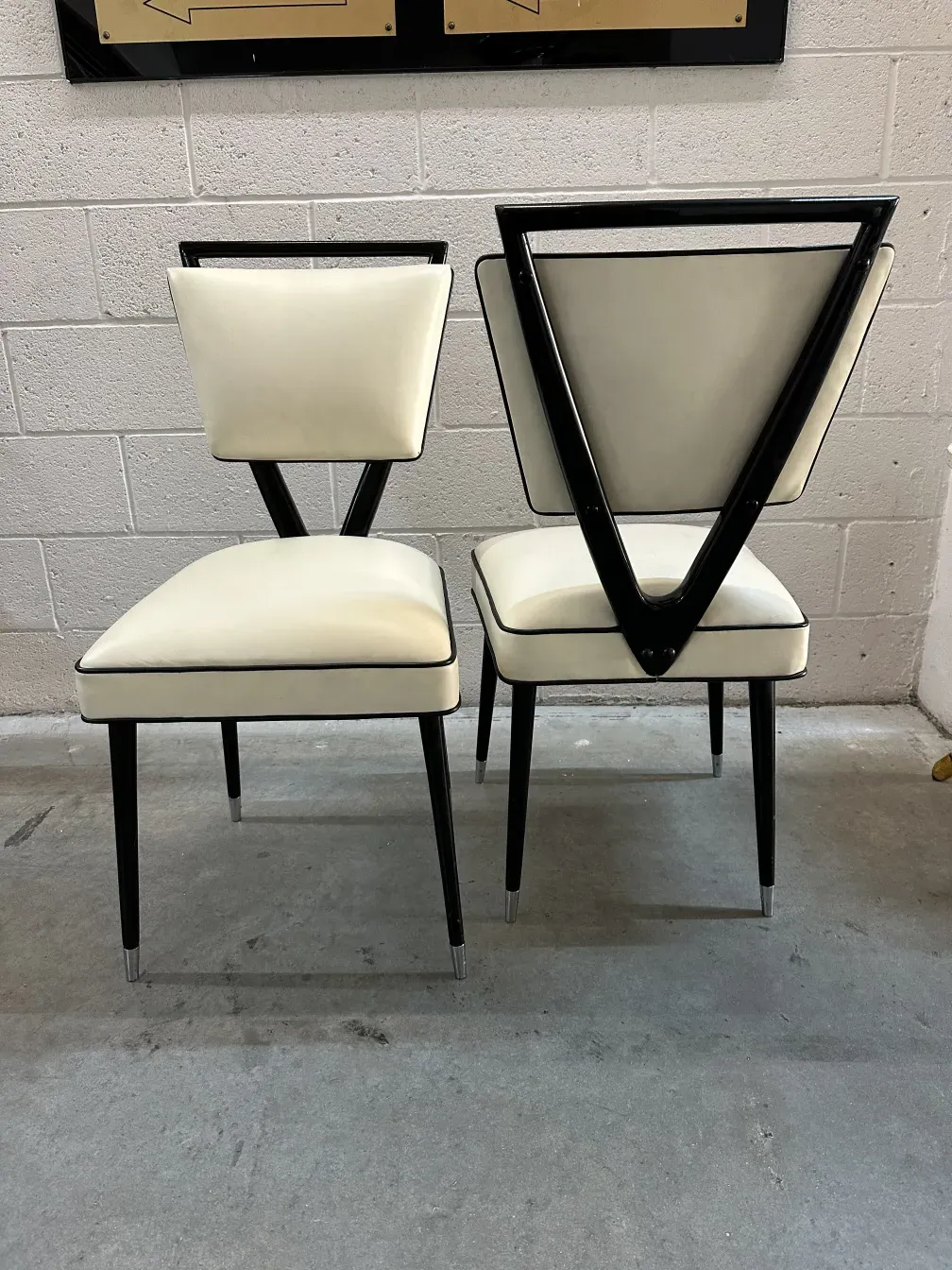 pair of antique chairs with V-shaped backs, white and black