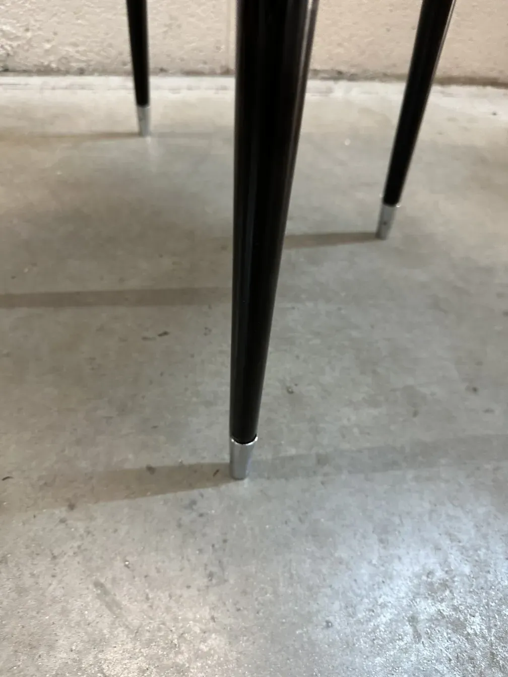 details of the legs of 2 antique chairs carlo mollino in a simple setting