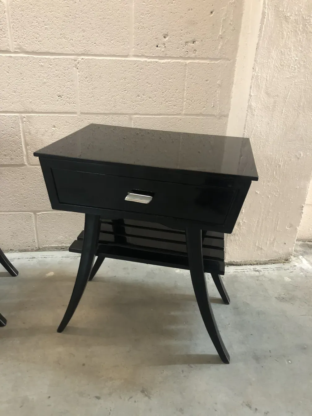 Antique bedside tables featuring appealing design, two legs and a drawer for bedroom convenience.