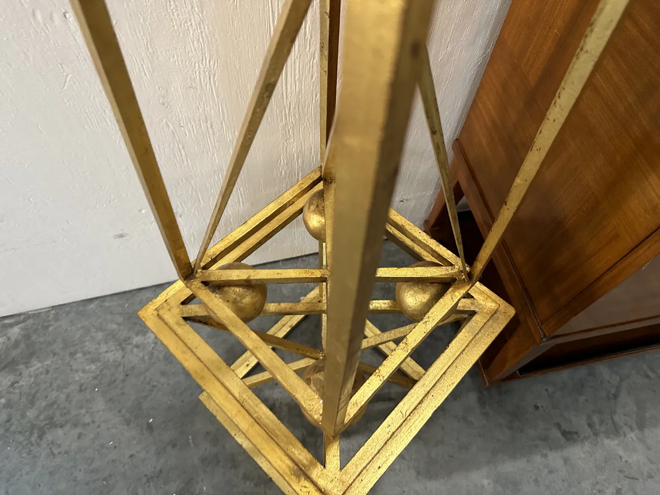 Top view of two decorative antique obelisks featuring geometric details and spheres at the base.