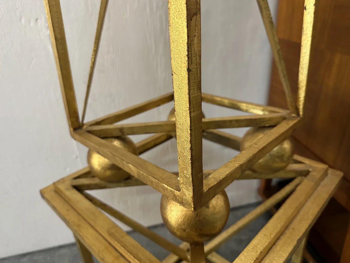 two antique obelisks with decorative golden details on a base.