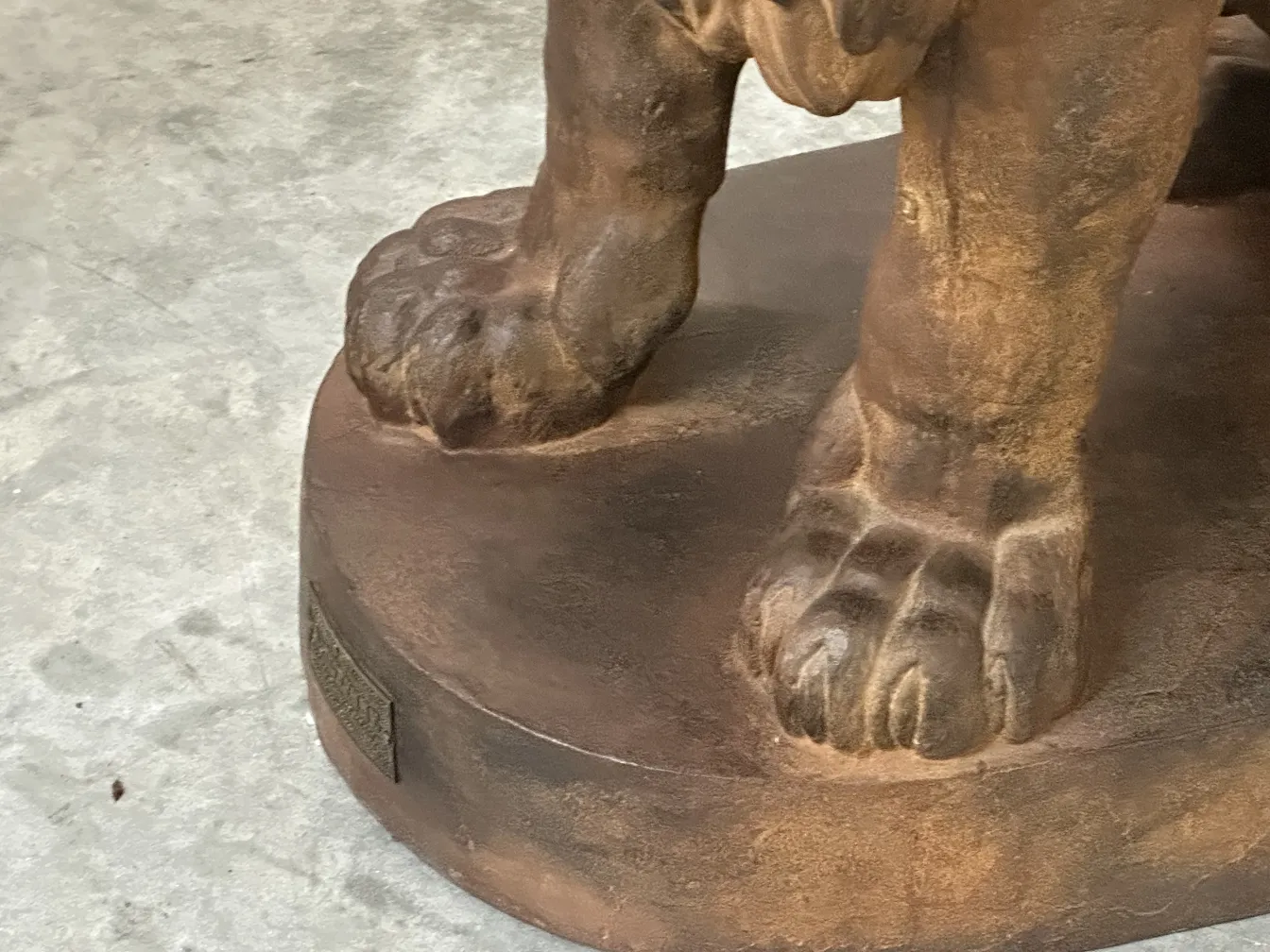 antique sculpture of 2 lions with detailed paws