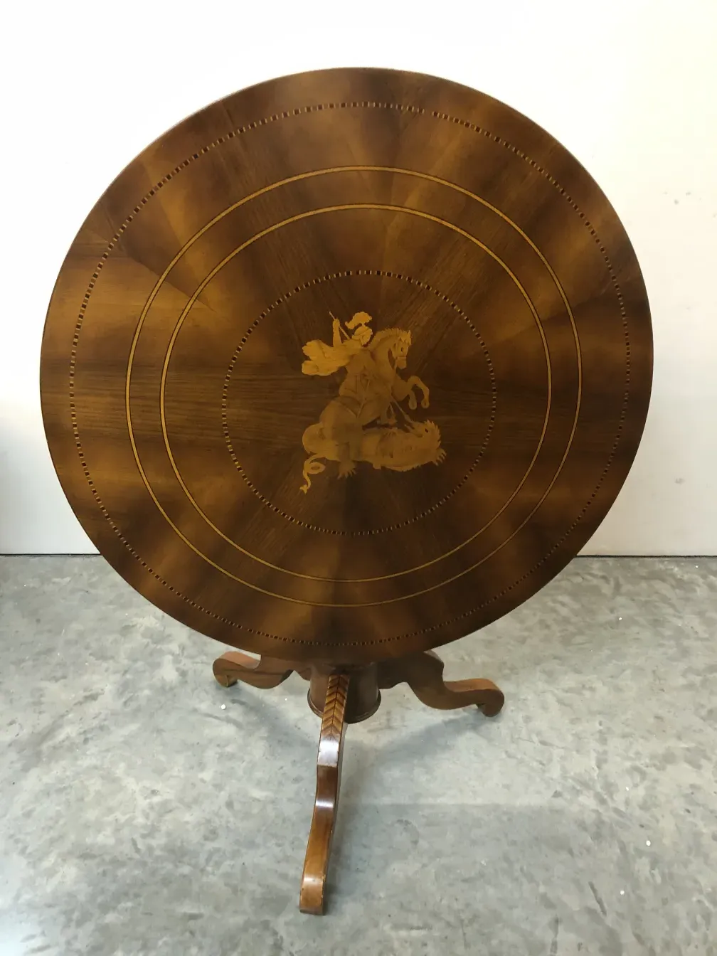 antique round table featuring an intricate design on top