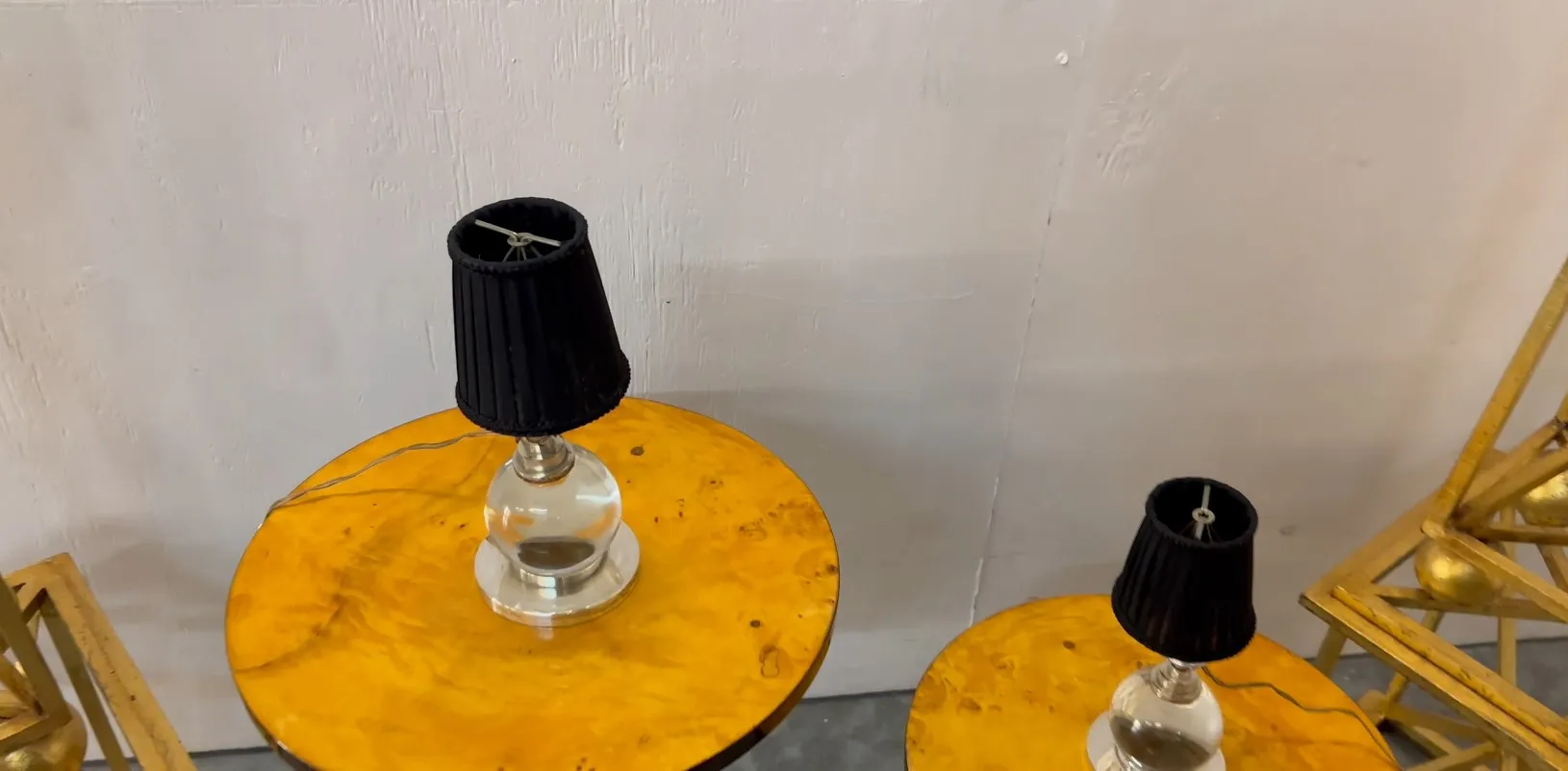 Two antique table lamps by Jacques Adnet on yellow round tables