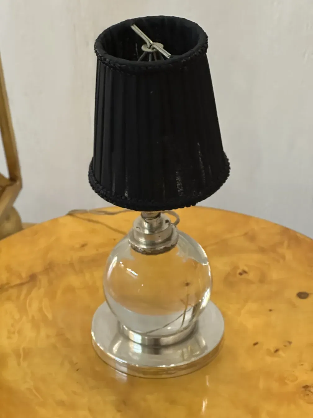 Two antique table lamps with a classic and elegant design by Jacques Adnet, in a cozy setting