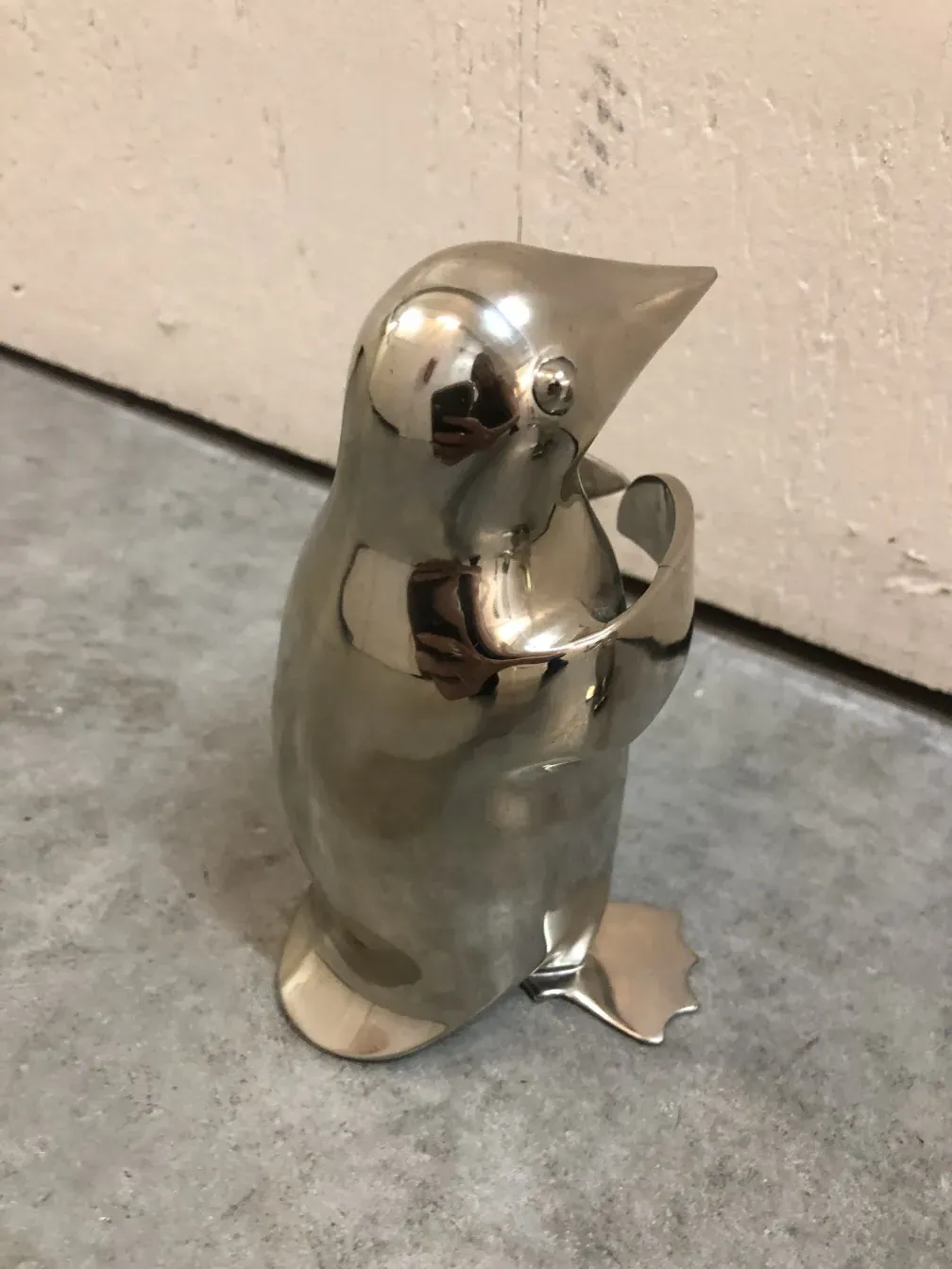 vintage sculpture of 2 penguins against a plain background