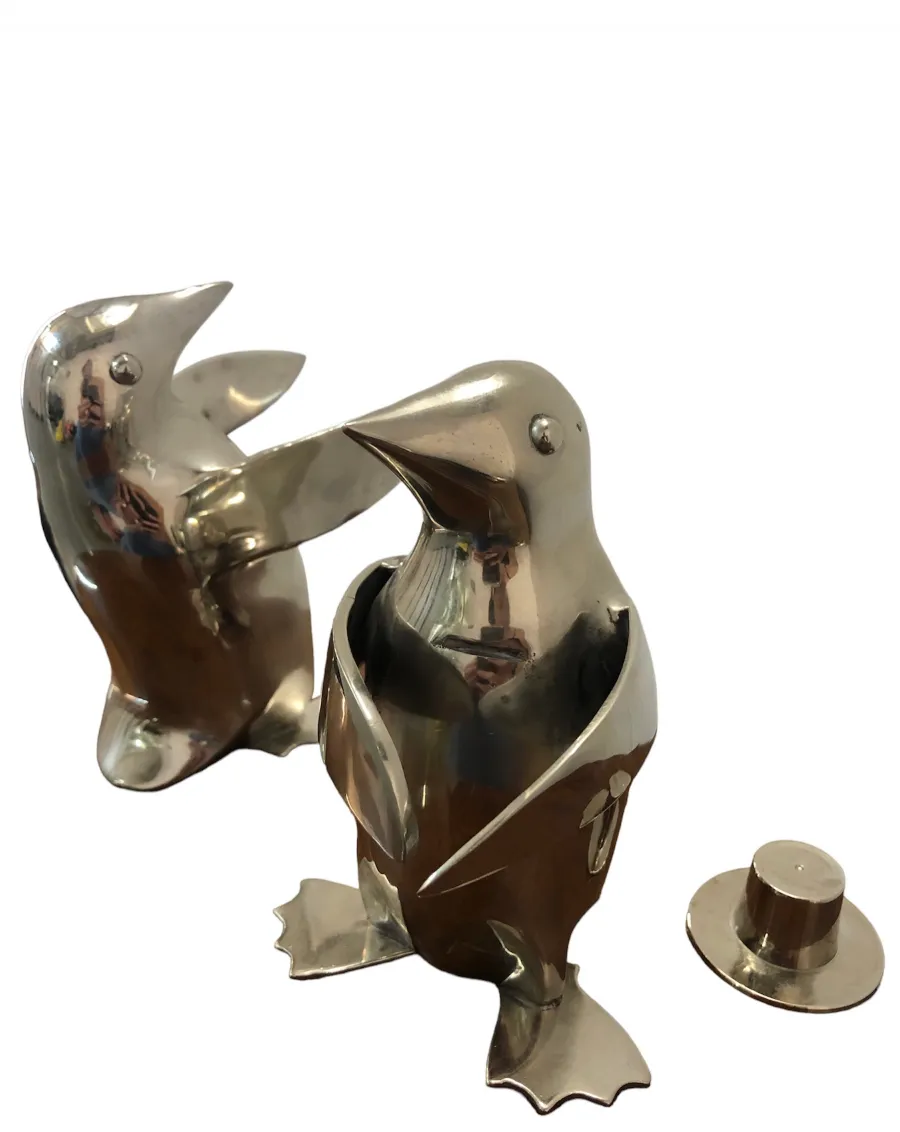 Two antique penguins in a playful stance, decorative.