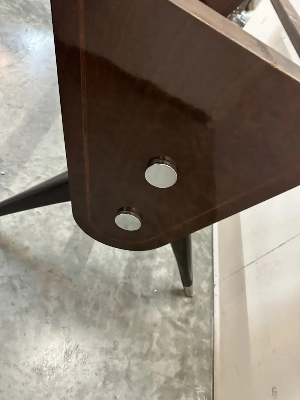 antique dining table featuring carlo mollino design and thin legs