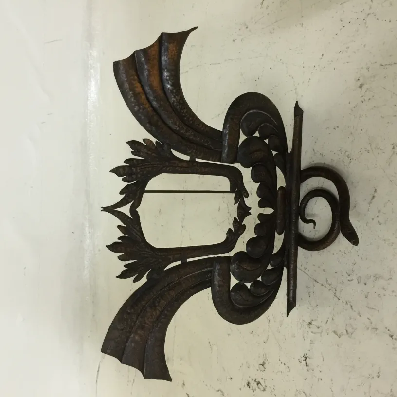 Antique picture frame with decorative design and ornate top details.