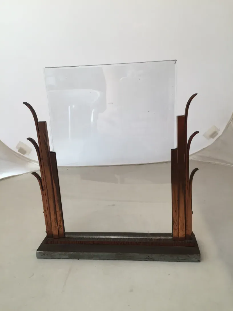 Antique picture frame with an elegant design in warm colors, light background