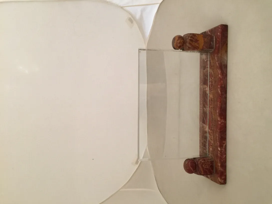 Decorative antique picture frame with base, perfect for displaying photos in an elegant environment.