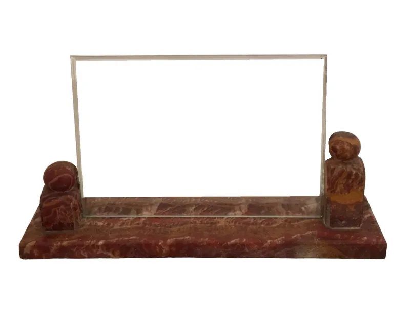 Antique picture frame with decorative base and space for photo.