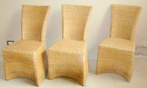 Antique dining table for four people with three uniquely designed chairs.