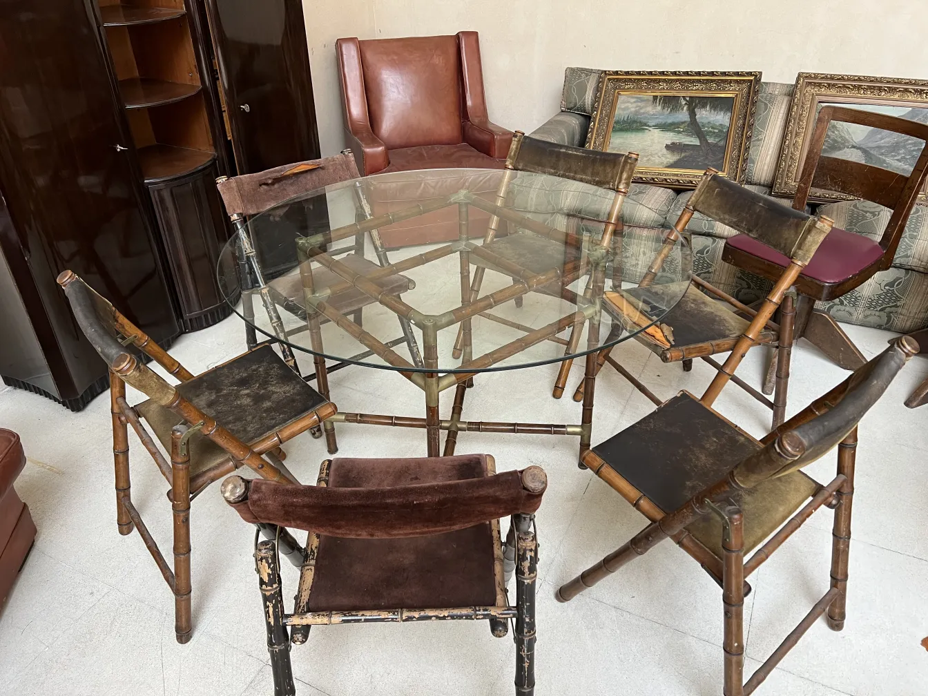 antique dining table with six simple chairs in a cozy environment, surrounded by vintage furniture.
