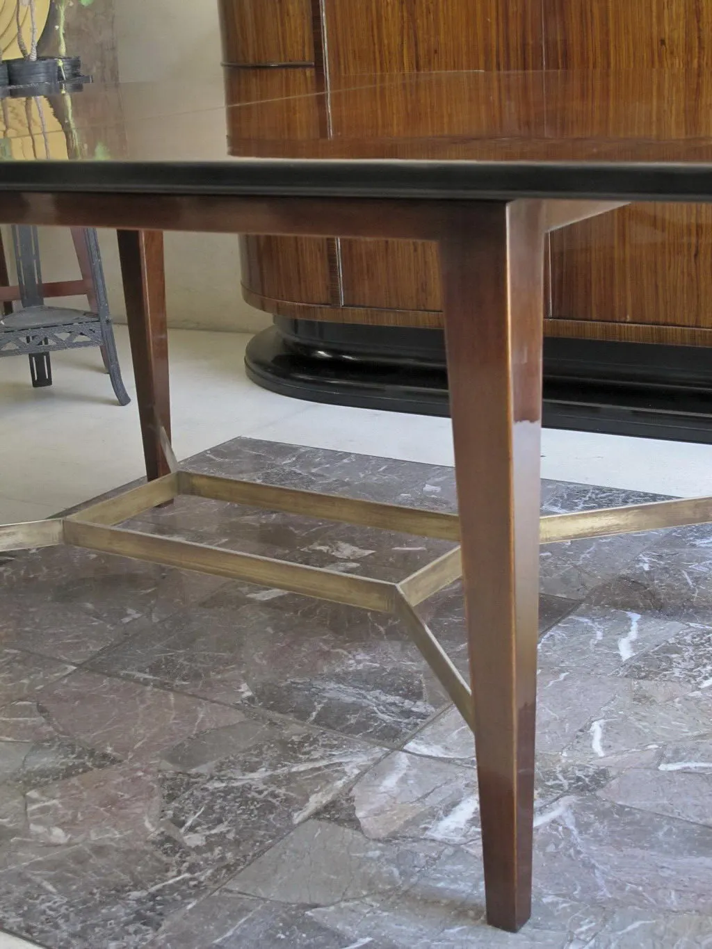 Antique dining table with elegant legs in a classic setting.