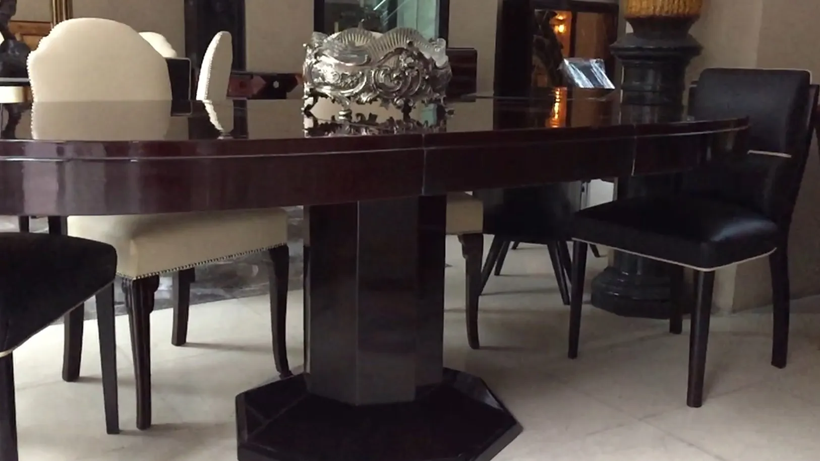 antique dining table featuring intricate designs in a classy setting.