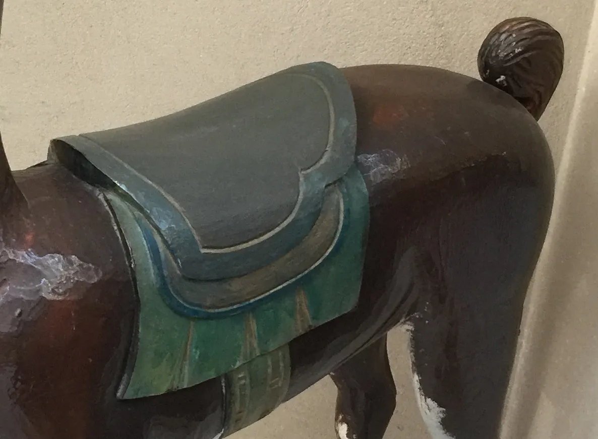 antique llama statue with details on the back