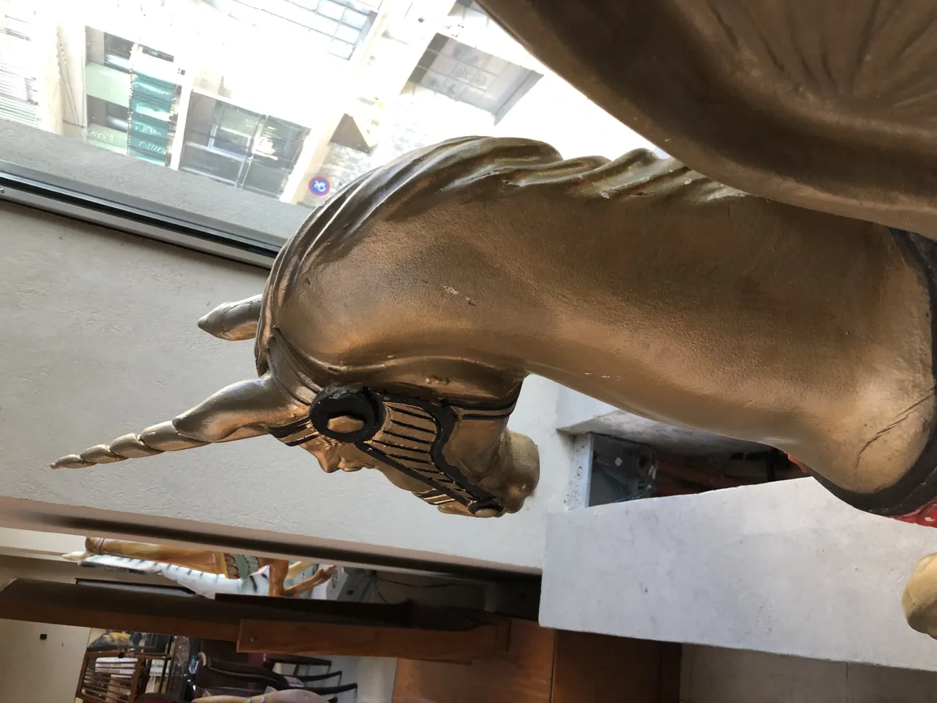 Antique sculpture of a golden unicorn with details