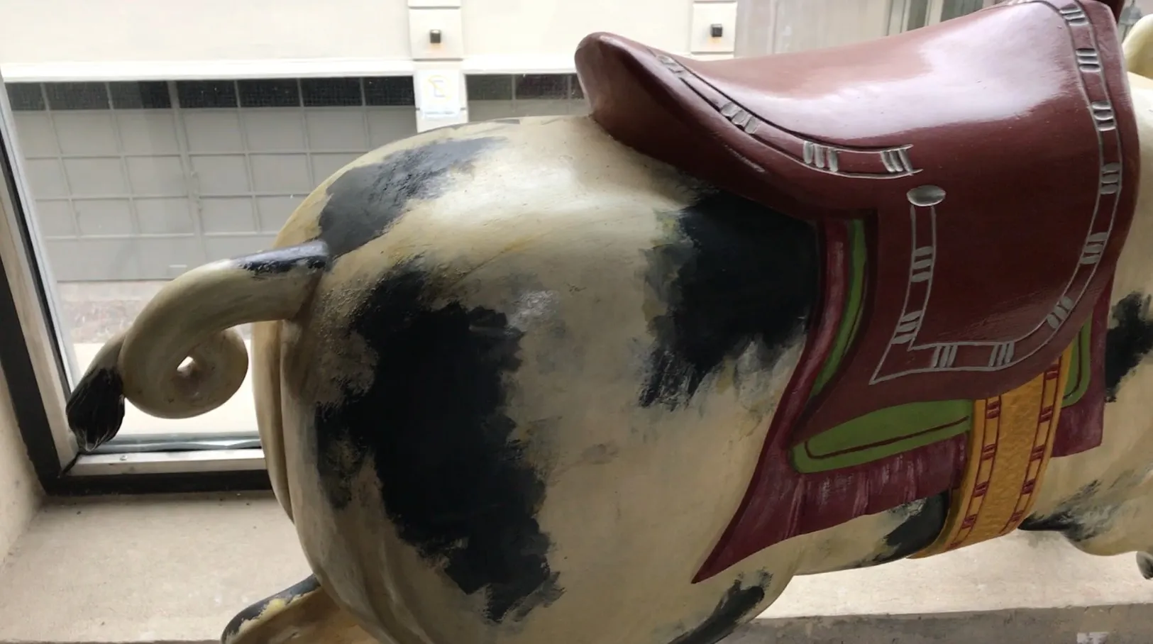 antique pig with decorative saddle in a setting