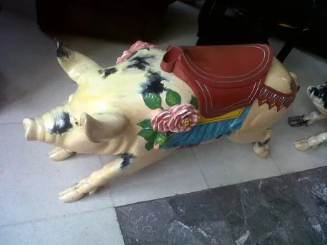 Antique decorative pig, painted with flowers and saddle.