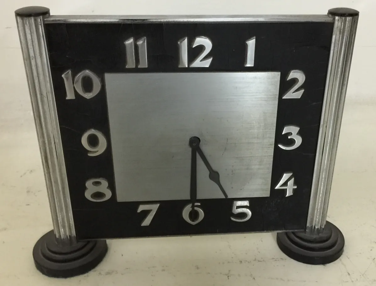 Antique tabletop clock with an elegant design and large numbers.