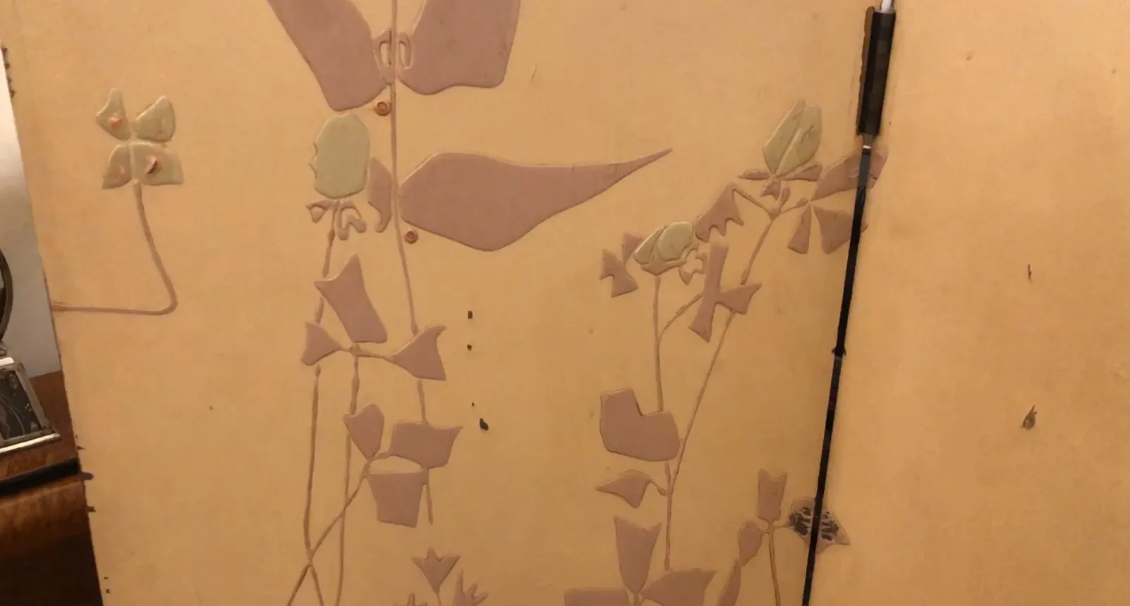 Antique folding screen with floral design on light background, vintage aesthetic