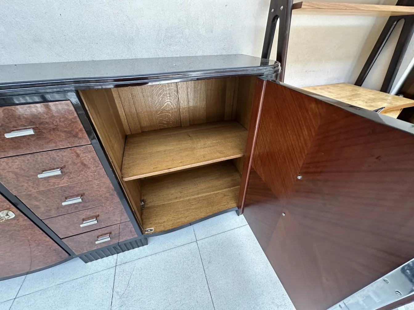 antique art deco sideboard with an elegant shape, showcasing its interior