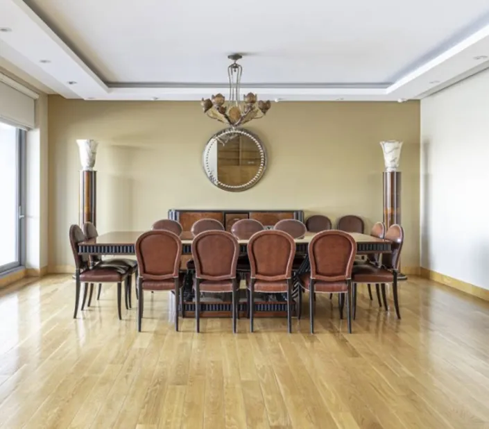 antique art deco mirror in an elegant living room with a table and chairs