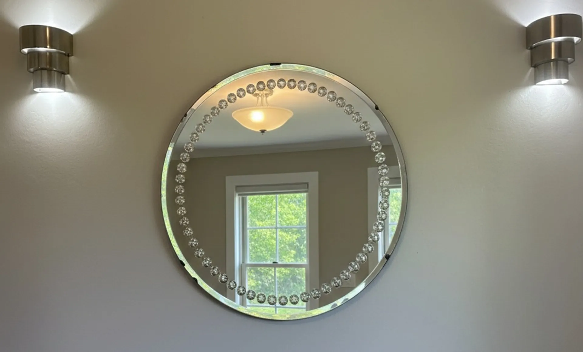 round antique mirror with decorative edges in a modern setting