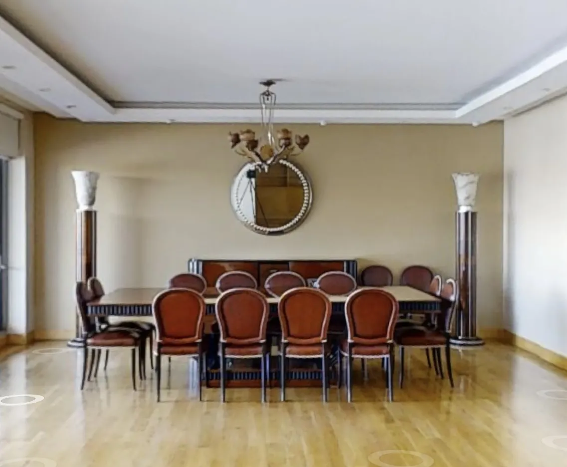 antique mirror in a room with a table and chairs